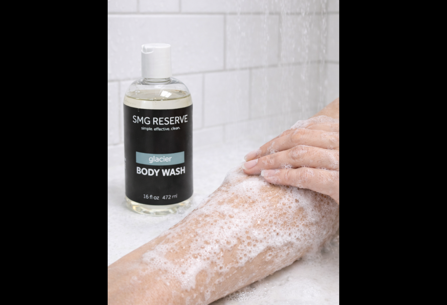 Person applying Glacier body wash to arm, creating a light foamy lather during shower use.