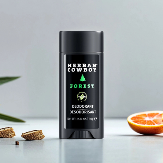 Herban Cowboy Forest deodorant surrounded by natural ingredients, plant-based men’s deodorant with a fresh, woodsy scent