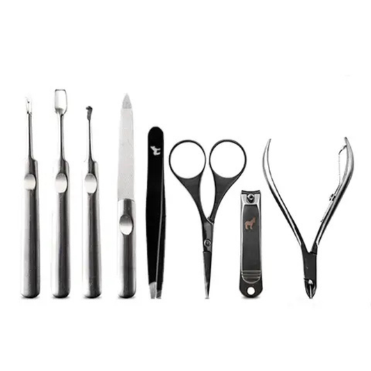 Stainless steel men’s manicure tools laid out individually on a white background, including nail clippers, scissors, tweezers, and cuticle tools.