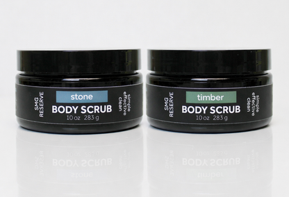 SMG Reserve exfoliating body scrub duo featuring Stone and Timber scents in black 10 oz jars on a white background