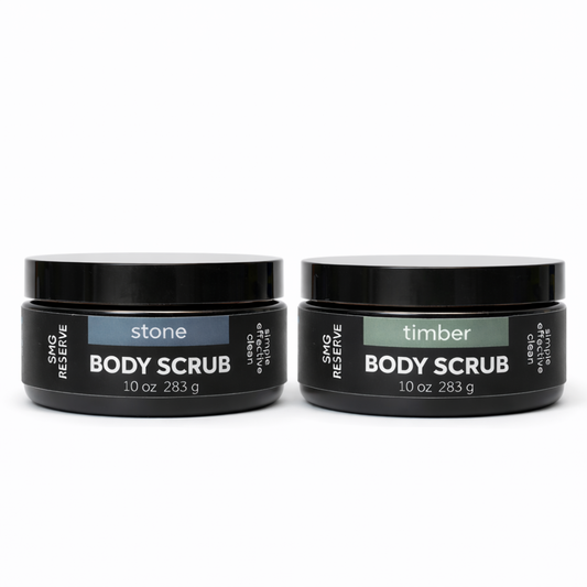 SMG Reserve body scrub jars in Stone and Timber scents, 10 oz black jars on a white background