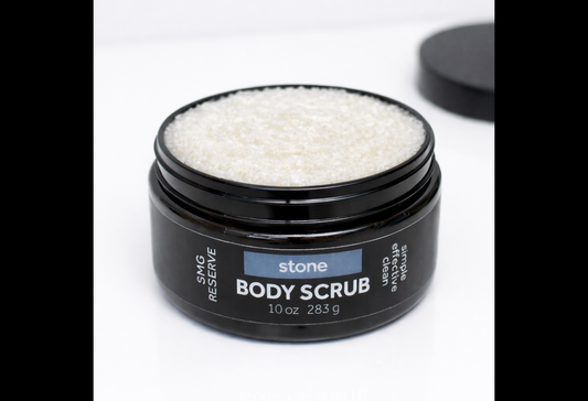 Close-up of Stone exfoliating body scrub showing white sugar scrub texture inside black jar